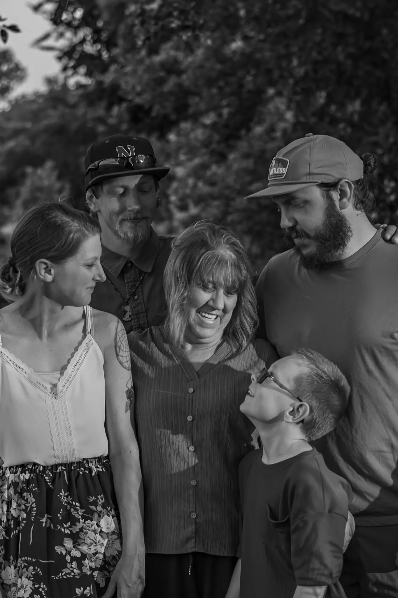 Multigenerational family gathered in a black-and-white portrait.
