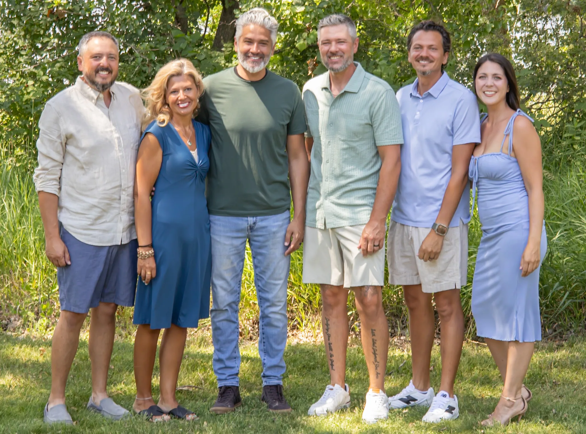 Extended family standing together for an outdoor portrait.