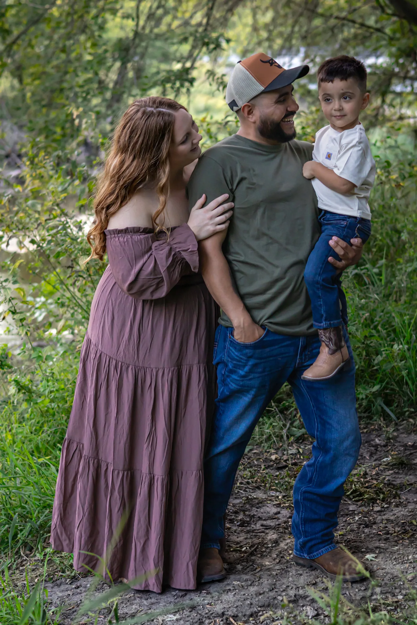 Family walking together through a wooded setting.
